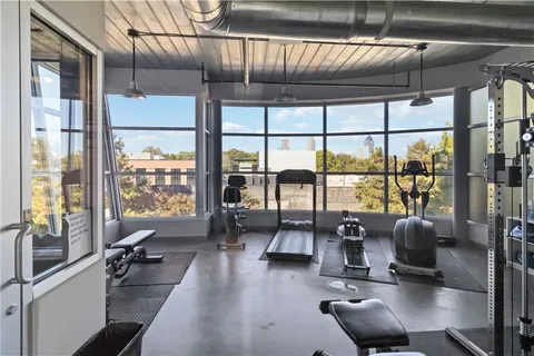 a view of a livingroom with couch and floor to ceiling window