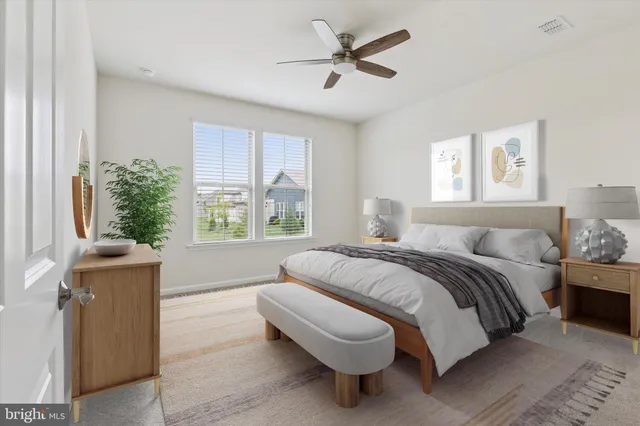 a spacious bedroom with a bed a couch and a window