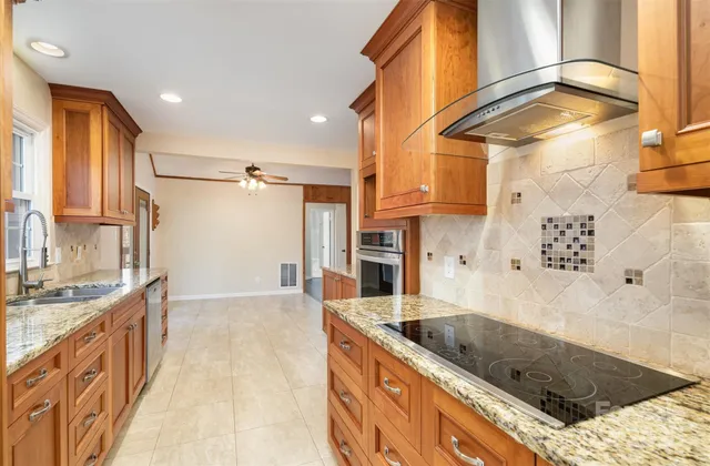 a kitchen with a sink a stove and a refrigerator