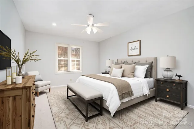 an empty room with a ceiling fan and a window