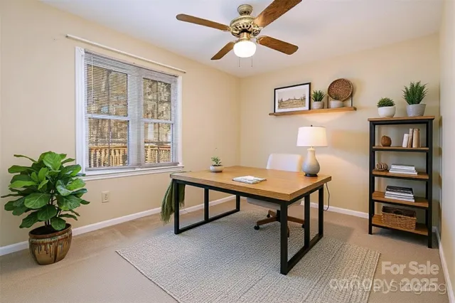 an empty room with a ceiling fan and a window