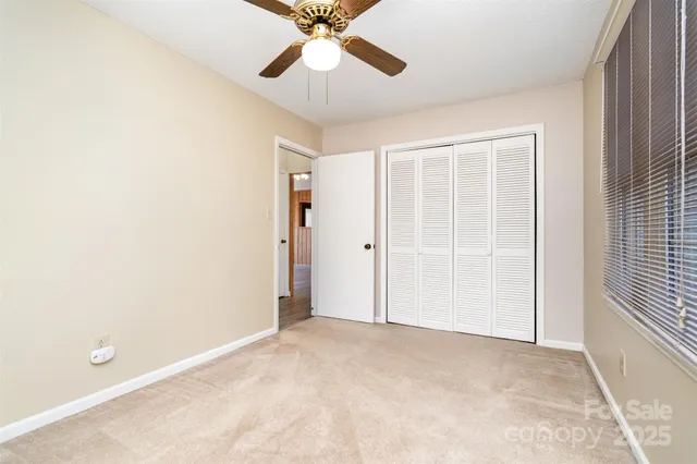 a bathroom with a granite countertop bathtub shower sink vanity mirror and toilet