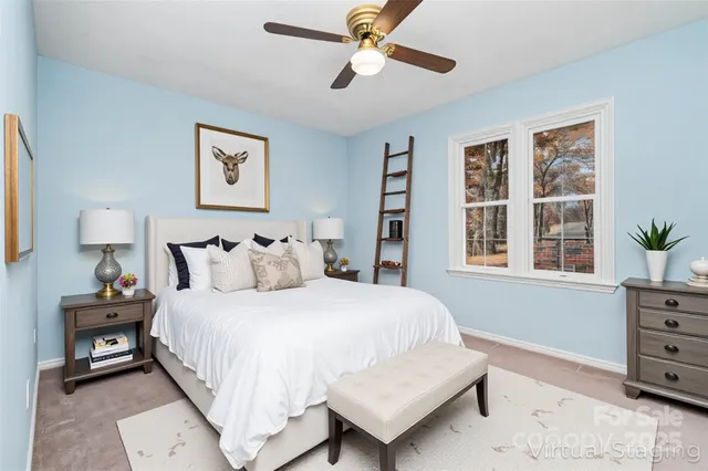 a view of a livingroom with a ceiling fan and window