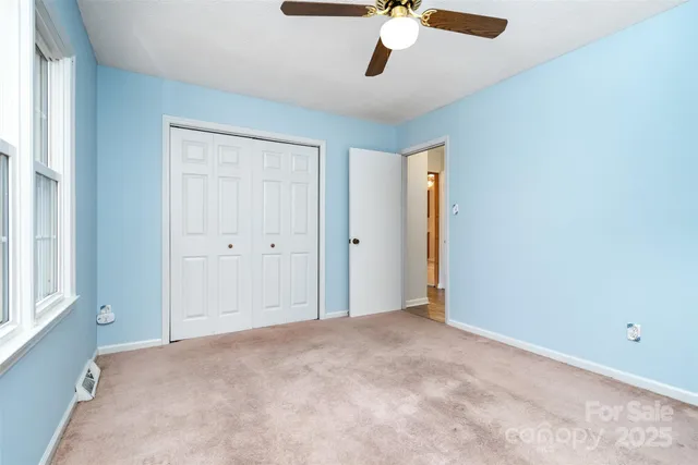 a view of a room with wooden floor and furniture