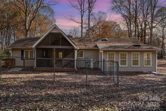 a view of dirt yard with large trees