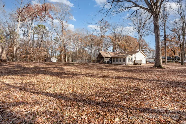 a view of house with a yard and covered with snow