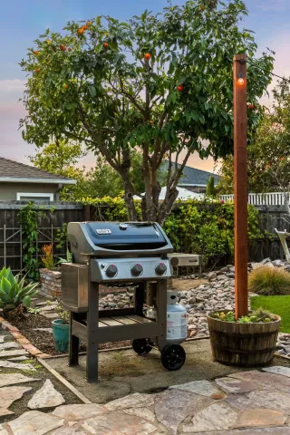 a view of a patio with table and chairs potted plants with wooden floor and fence