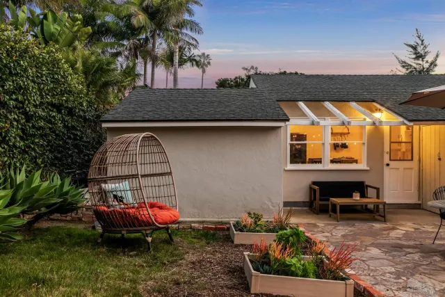 a front view of a house with a garden
