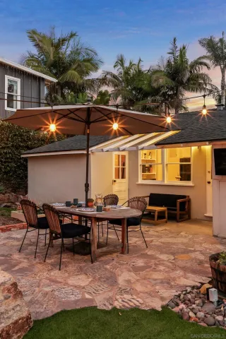 a view of a house with pool and sitting area