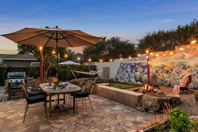 a view of a outdoor sitting area with furniture and umbrella
