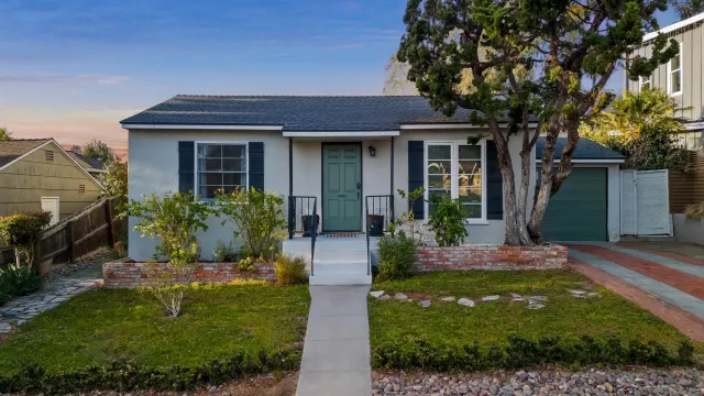 a front view of a house with a yard