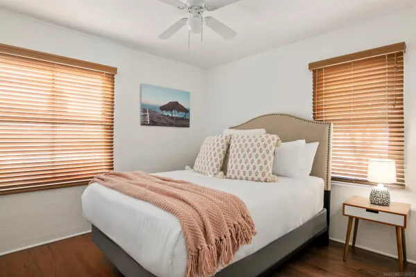 a bedroom with a bed and a window