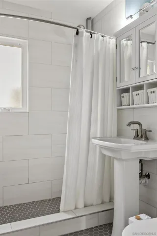 a bathroom with a shower and a sink