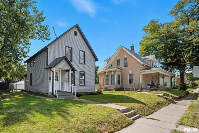 a front view of a house with a yard and porch