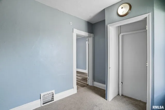 a view of a hallway with a wooden door