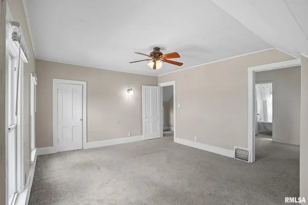 a view of an empty room with a ceiling fan