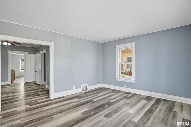a view of a livingroom with wooden floor and a window