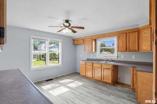 a view of a kitchen with a sink cabinet and a window