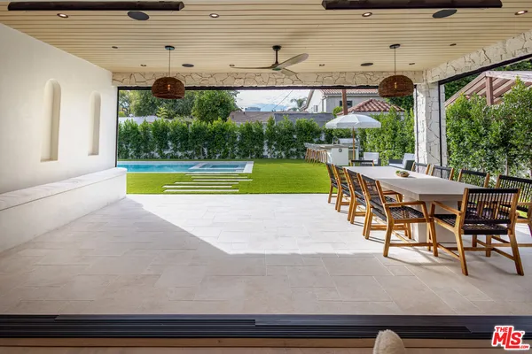 a dining space with furniture and garden view