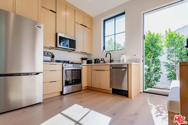 a bedroom with a bed and a large mirror