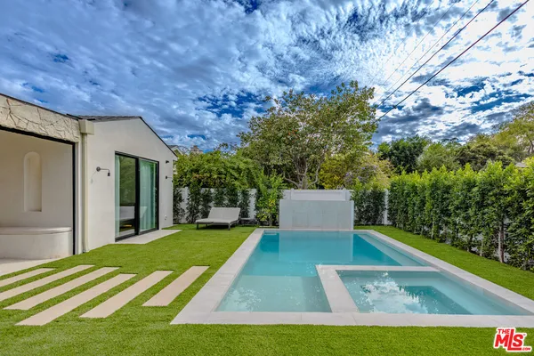 a view of a backyard with large trees