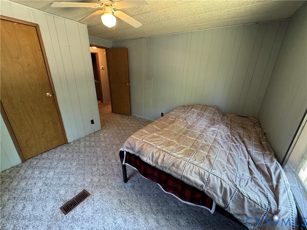 371 Horseshoe Road Jarratt, VA 23867 - Photo 20 of 21 a bed sitting in a room next to a window