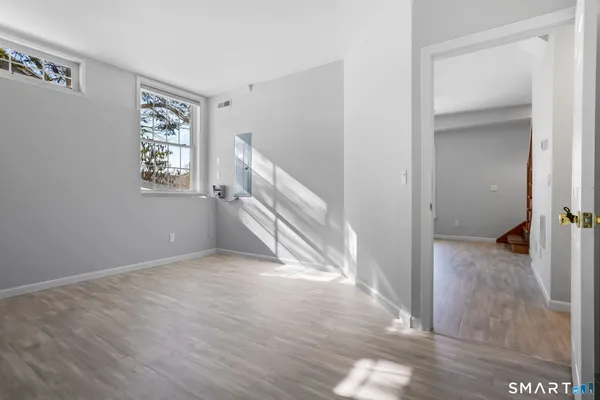 a view of entryway and hall with wooden floor