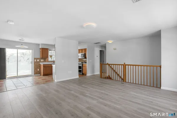 a view of a kitchen with wooden floor and a kitchen