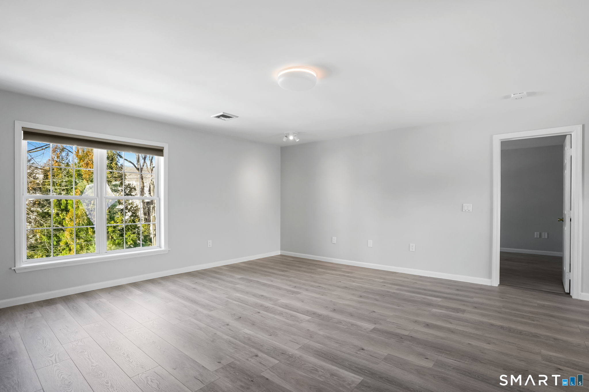 19 Candlewood Springs Road New Milford, CT 06776 - Photo 17 of 40 an empty room with wooden floor and windows