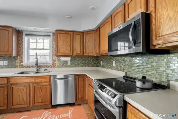 a kitchen with a sink stove top oven and cabinets