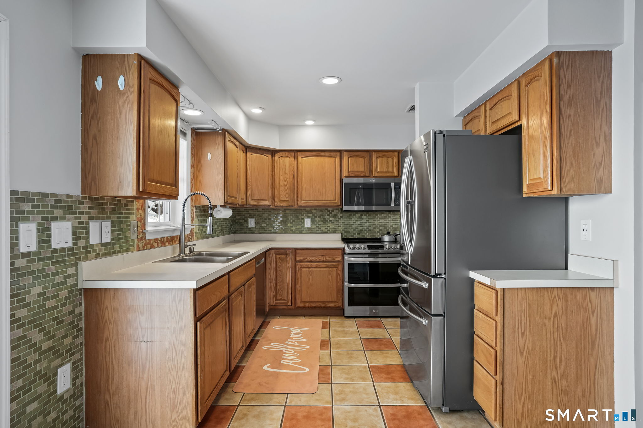 19 Candlewood Springs Road New Milford, CT 06776 - Photo 20 of 40 a kitchen with stainless steel appliances granite countertop a sink stove refrigerator and cabinets