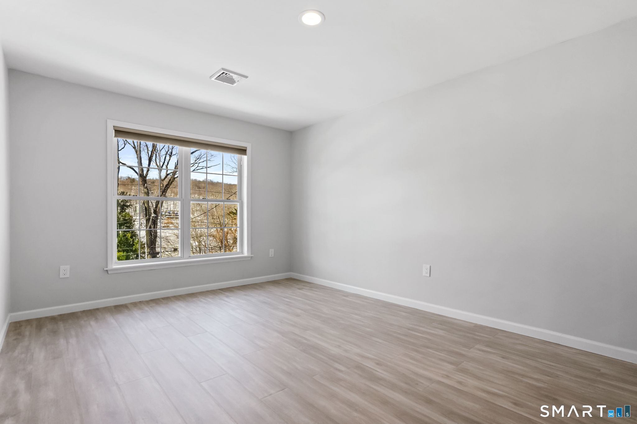 19 Candlewood Springs Road New Milford, CT 06776 - Photo 25 of 40 a view of an empty room with wooden floor and a window