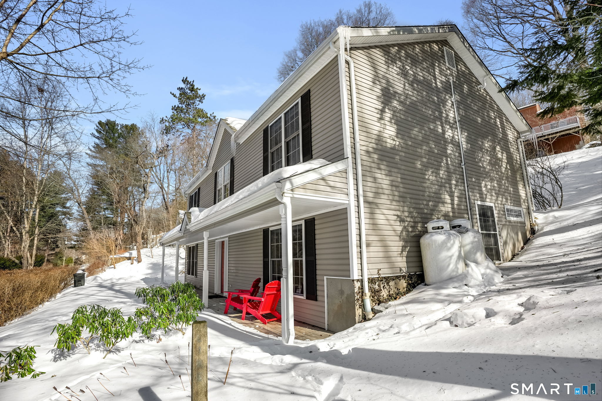 19 Candlewood Springs Road New Milford, CT 06776 - Photo 39 of 40 a view of a house with a small yard and potted plants