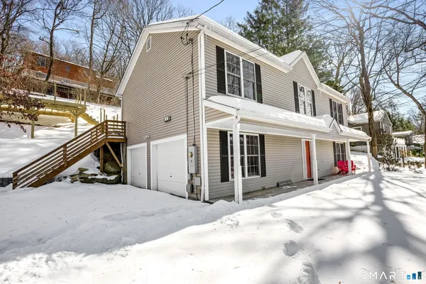 a view of a house with a snow in the yard