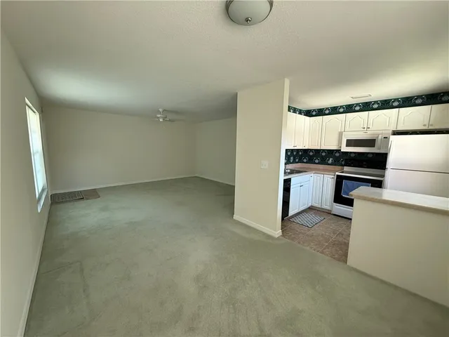 a kitchen with granite countertop a sink and stainless steel appliances