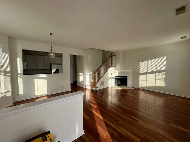 wooden floor in an empty room with a window and wooden floor