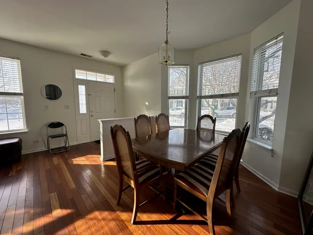 a view of a dining room with furniture window and wooden floor