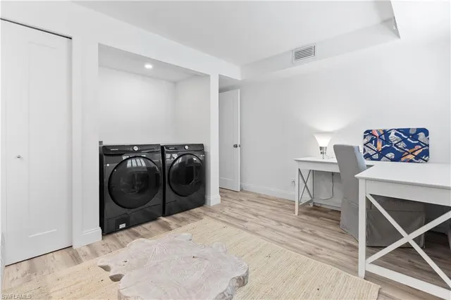 a view of a storage & utility room with a washer dryer