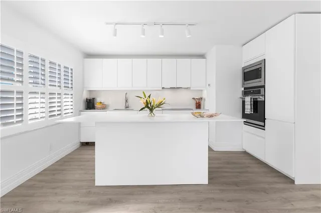 a kitchen with stainless steel appliances a refrigerator sink and cabinets