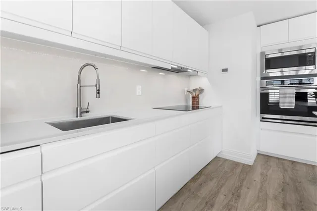 a kitchen with a sink and an oven