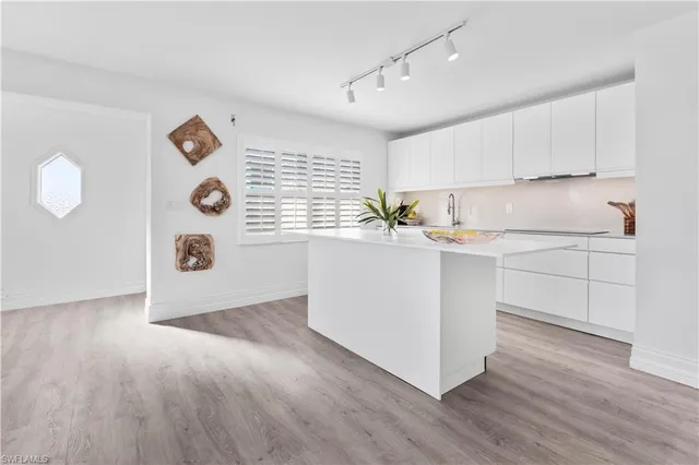 a room with a white cabinets furniture and a window