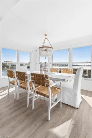 a living room with stainless steel appliances kitchen island granite countertop a table chairs and a kitchen view