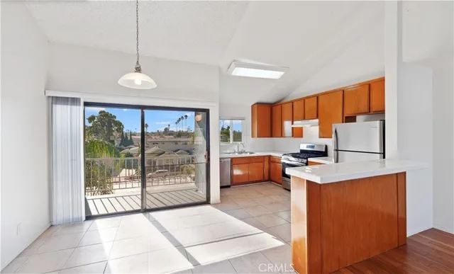 a kitchen with a refrigerator a stove a sink and dishwasher