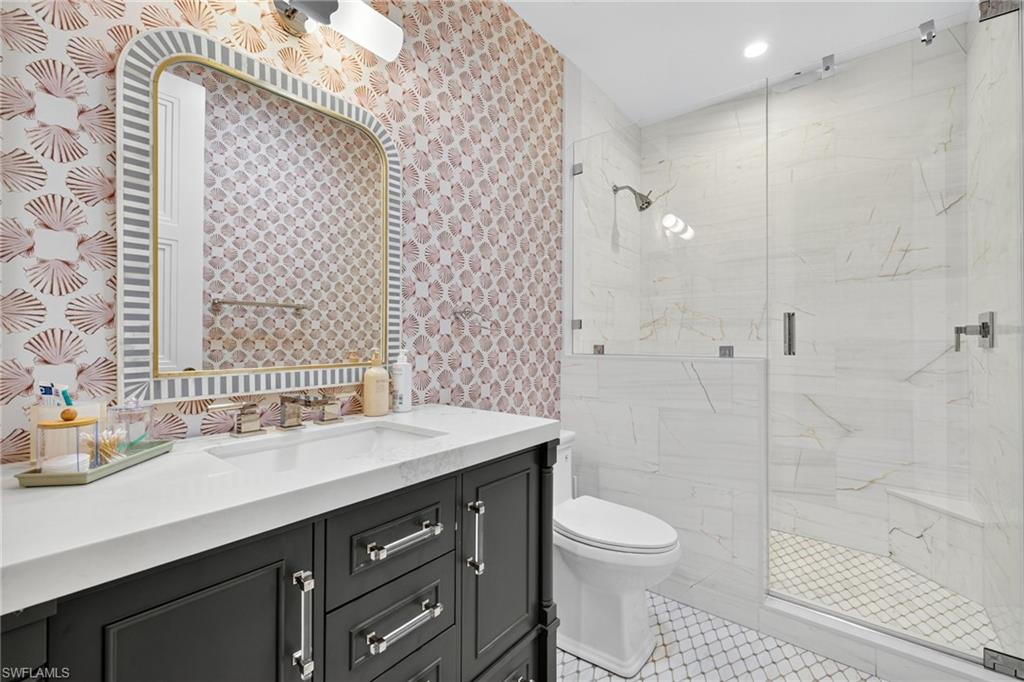 111 Caribbean Road Naples, FL 34108 - Photo 38 of 50 a bathroom with a sink a toilet and shower