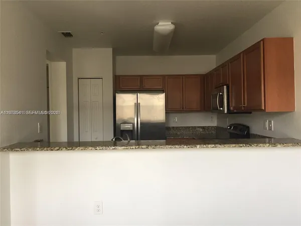 a view of a kitchen with a sink and cabinets