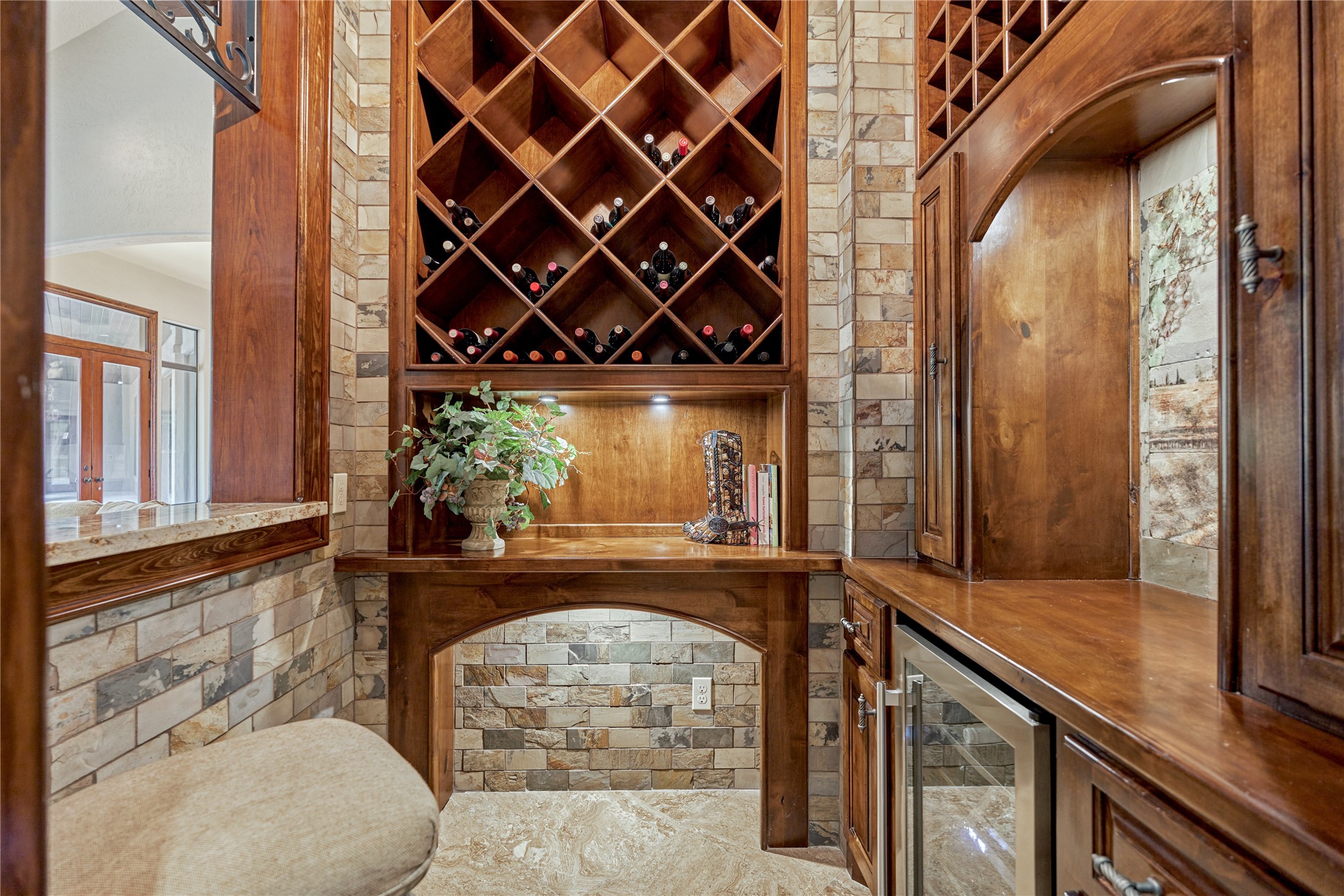 24803 Pearl Crest Lane Spring, TX 77389 - Photo 16 of 50 Wine Room with grotto and wine refrigerator boasts stone wall and rich wood accents. Note: Don’t miss the beautiful mosaic— not pictured here.