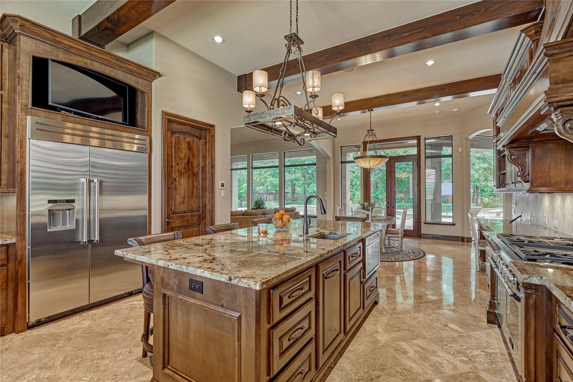 24803 Pearl Crest Lane Spring, TX 77389 - Photo 21 of 50 Kitchen features include a built-in refrigerator, walk-in pantry with cabinets and shelving, Alder cabinets with soft-close hinges, a built-in coffee maker, a pop-up electrical outlet on the island, and more!