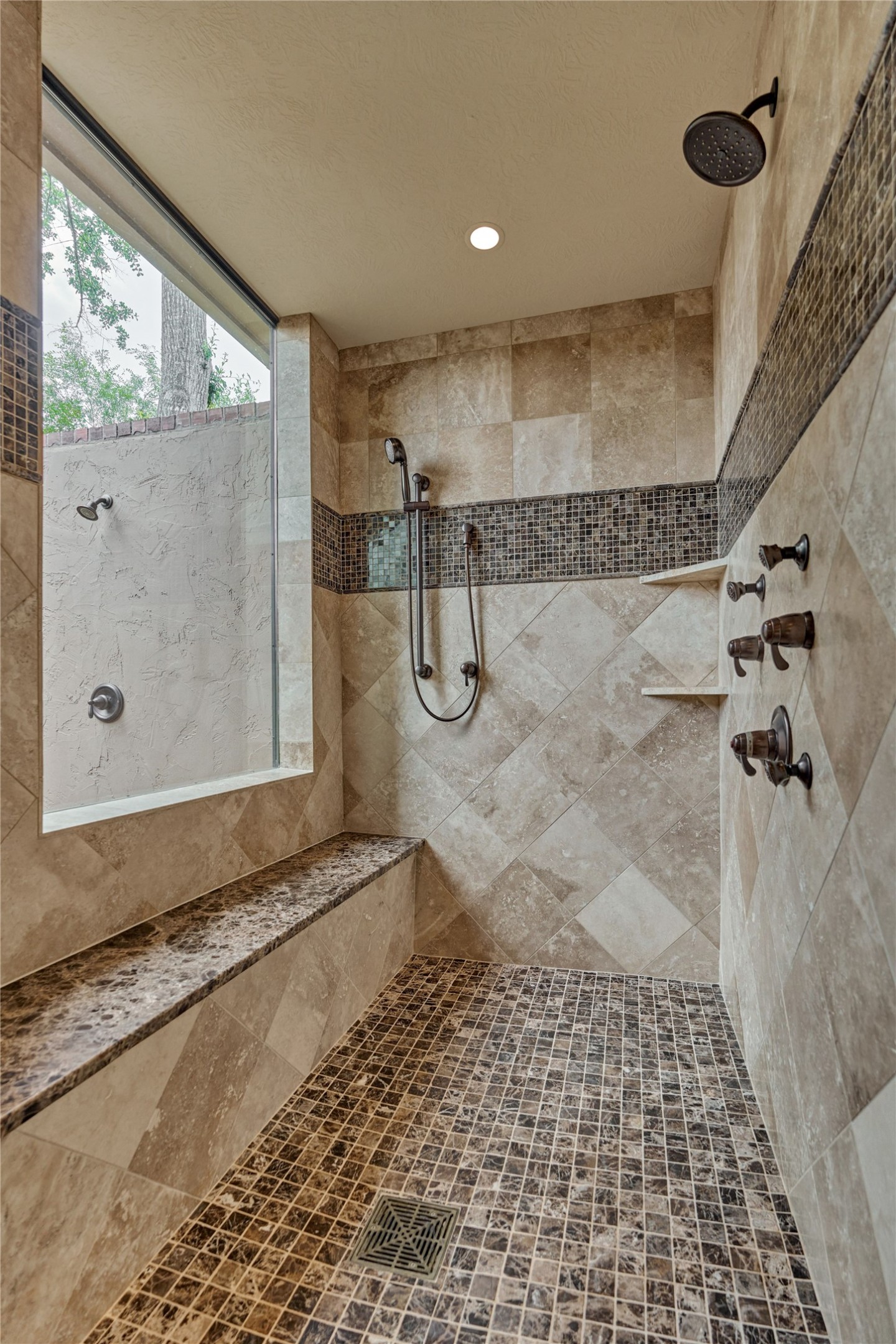 24803 Pearl Crest Lane Spring, TX 77389 - Photo 30 of 50 Large walk-in shower with multiple showerheads. Note: the outdoor shower through the window to the private courtyard.