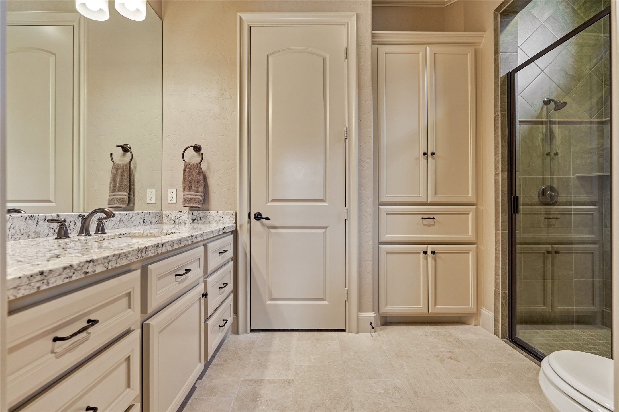 24803 Pearl Crest Lane Spring, TX 77389 - Photo 33 of 50 Full en suite bathroom for secondary bedroom #1 features a walk-in shower and built-in storage.