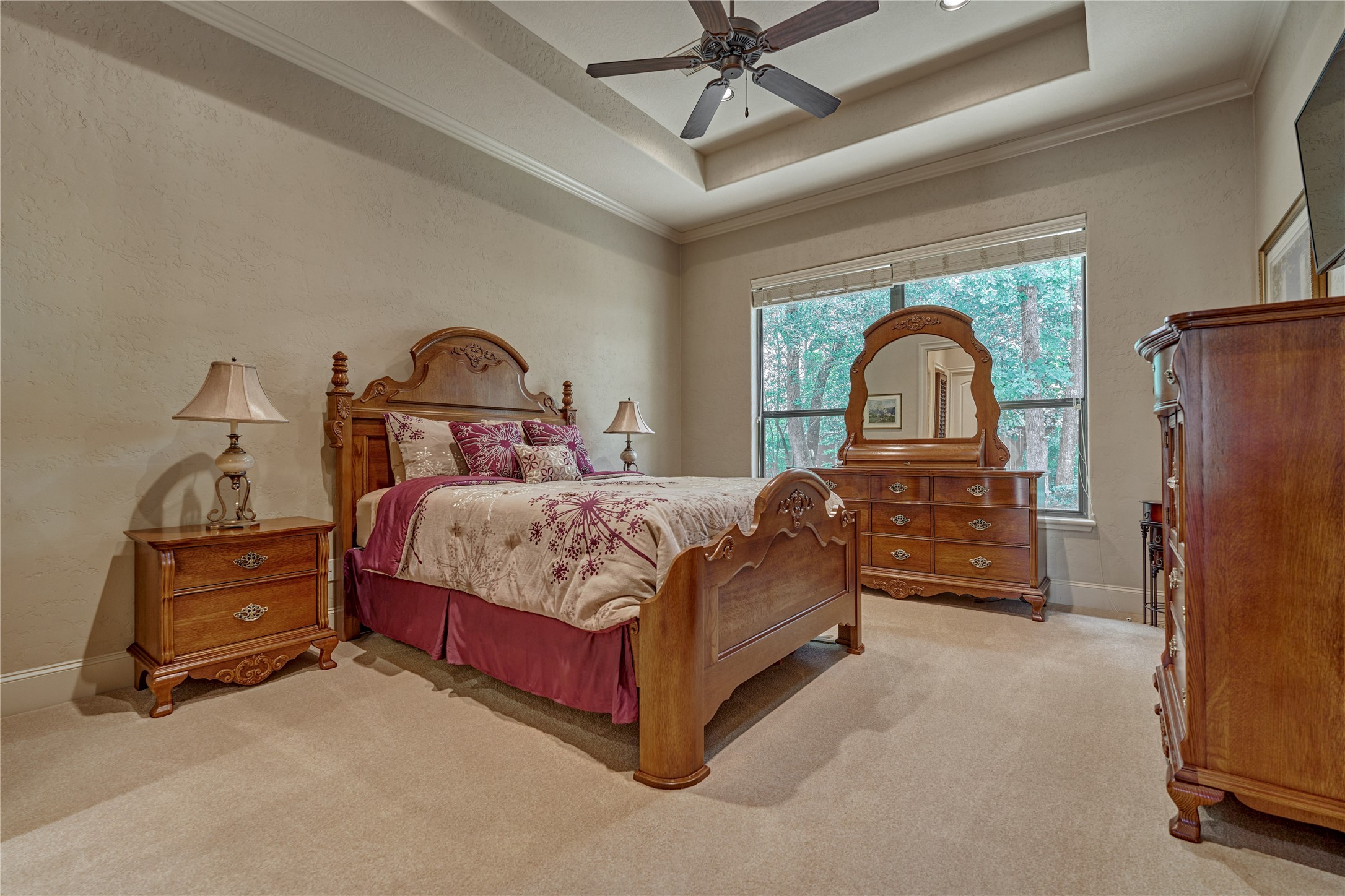 24803 Pearl Crest Lane Spring, TX 77389 - Photo 36 of 50 Secondary bedroom #3 features a trayed ceiling, plush carpeting, and a ceiling fan.